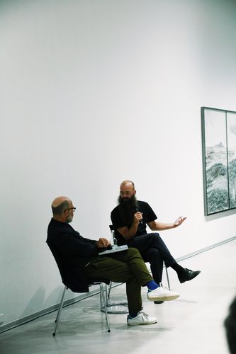 Impressions Book Launch and Artist Talk with Julius von Bismarck Two people are having a conversation while sitting on chairs in the exhibition space.