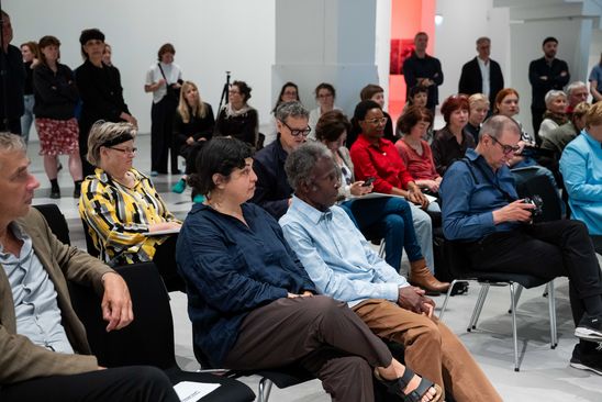 Photo: View of the participants at the press conference. Akinbode Akinbiyi and Özlem Altın sit in the front row.