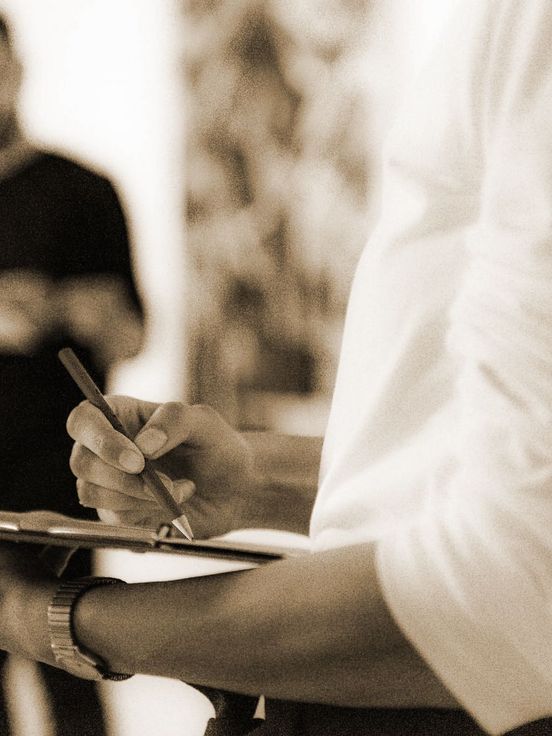 Photo: A person draws on a clipboard.